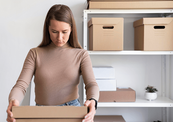 woman packing boxes international sales